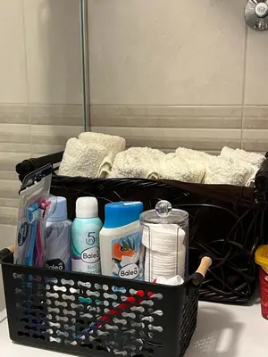 a basket full of toiletries sitting on a counter at Apartman Pannonica Centar in Tuzla