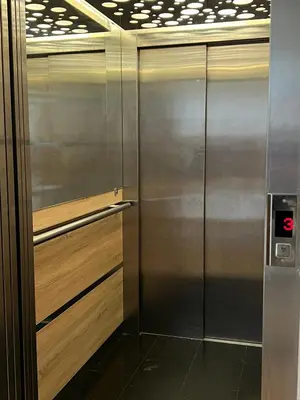 a stainless steel elevator in a room at Apartman Pannonica Centar in Tuzla