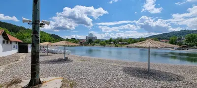 a view of a river with a cross on a pole at Apartman Pannonica Centar in Tuzla