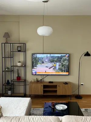 a living room with a flat screen tv on a wall at Apartman Pannonica Centar in Tuzla