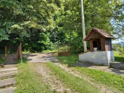 a small dog house on the side of a dirt road at Kuća Knežević in Mlječanica