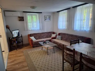 a living room with a couch and a table at Kuća Knežević in Mlječanica