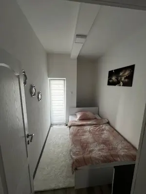 a small bedroom with a bed and a window at Apartmani Una Lux2 in Spilja