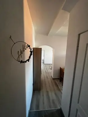a hallway with a door with a wreath on the wall at Apartmani Una Lux2 in Spilja