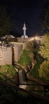 a lighthouse on top of a building with a waterfall at San Travnik in Travnik