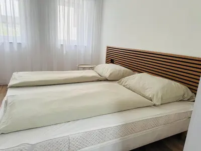 two beds with white sheets and pillows in a bedroom at San Travnik in Travnik