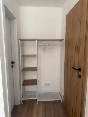 a walk in closet with a glass door and a stairway at San Travnik in Travnik