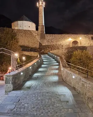 a stone staircase leading up to a lighthouse at night at San Travnik in Travnik