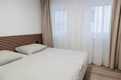 a bedroom with a white bed and a window at San Travnik in Travnik