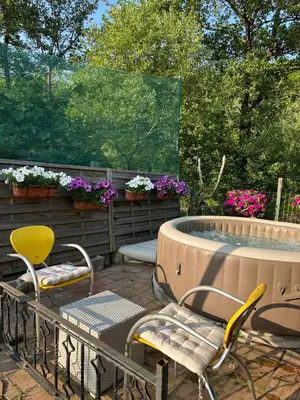 a patio with a table and chairs and a fountain at Apartman Green River Banja Luka in Bijeli Potok