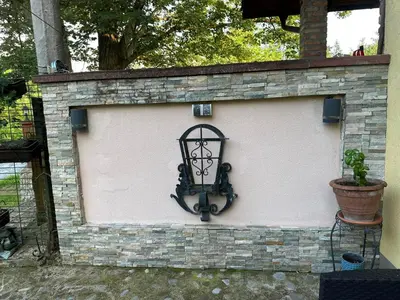 a brick wall with a sign on it at Apartman Green River Banja Luka in Bijeli Potok