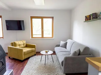 a living room with a couch and a chair at Guest House Seka in Bihać