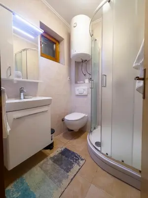 a bathroom with a toilet sink and a shower at Guest House Seka in Bihać