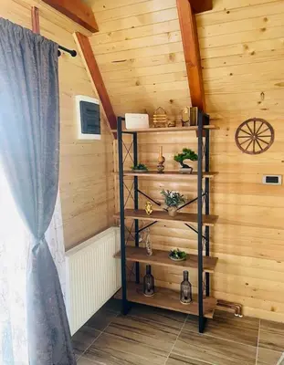 a room with a wooden wall with wooden shelves at Planinska kuća Jelka in Mlinište