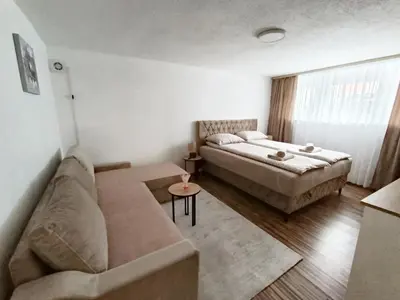 a living room with a bed and a couch at Apartman 4A in Bihać