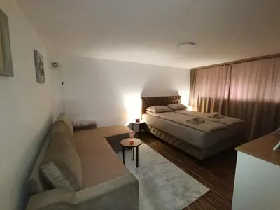 a living room with a bed and a couch at Apartman 4A in Bihać