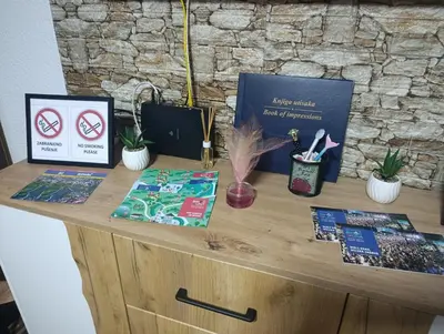 a desk with books and other items on it at Apartman 4A in Bihać