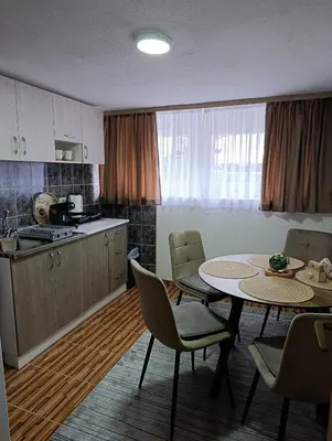 a kitchen and dining room with a table and chairs at Apartman 4A in Bihać
