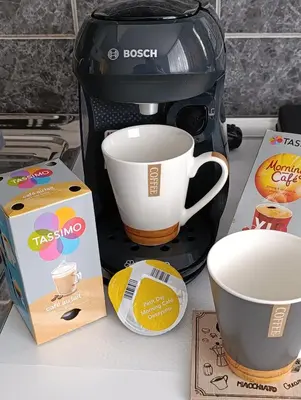 a coffee maker with a cup and a box on a counter at Apartman 4A in Bihać