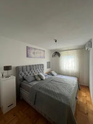 a bedroom with a large bed in a room at Apartman Murtić in Bihać