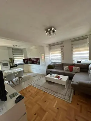 a living room with a couch and a table at Apartman Murtić in Bihać