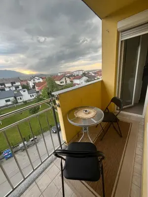 a balcony with a table and chairs and a view at Apartman Murtić in Bihać
