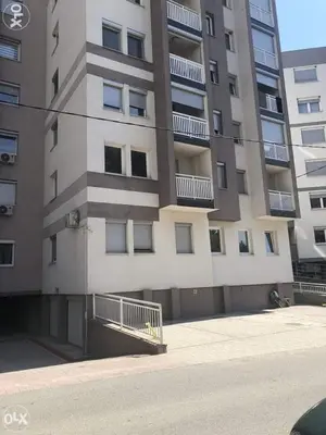 a large apartment building with balconies on the side of it at Stan na dan Srebrenik in Srebrenik