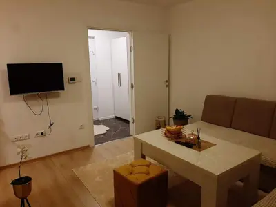 a living room with a couch and a table at Stan na dan Srebrenik in Srebrenik