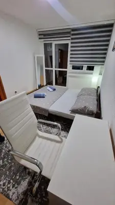 a room with a bed and a desk and a chair at Apartman A-D in Bihać