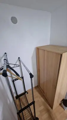 a ladder in a room with a wooden cabinet at Apartman A-D in Bihać