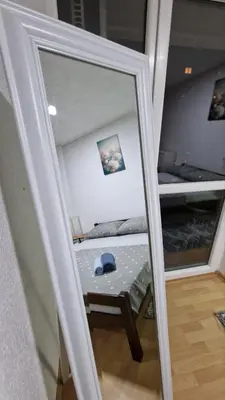a mirror reflection of a bed in a room at Apartman A-D in Bihać