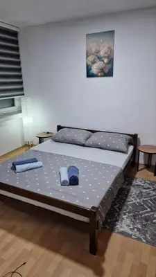 a bed in a room with two pillows on it at Apartman A-D in Bihać