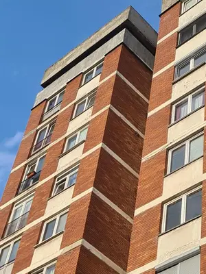a tall brick building against a blue sky at Apartman A-D in Bihać