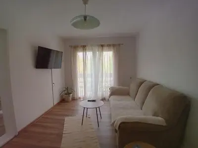 a living room with a couch and a table at RelaxApartment in Tuzla