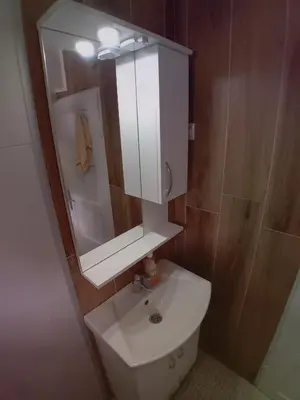 a bathroom with a white sink and a mirror at RelaxApartment in Tuzla