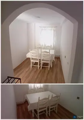 a white dining room with a table and chairs at RelaxApartment in Tuzla