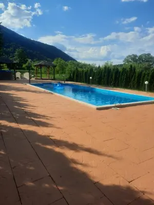 a large swimming pool with a gazebo in a park at Arena 2 in Ripač