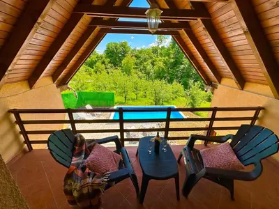 a room with two chairs and a table and a window at Foresta Home in Gradačac