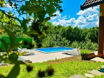 a swimming pool in a yard with some chairs at Foresta Home in Gradačac