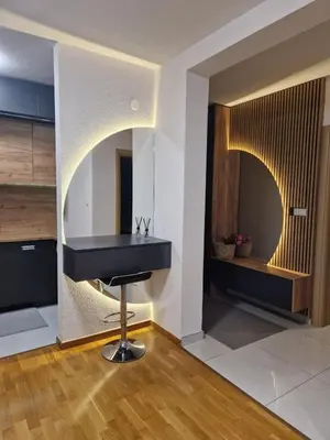 a kitchen with a black counter in a room at Apartman 3 Tuzla in Tuzla