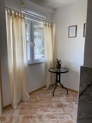 a small table in a room with a window at Apartman Fad in Bihać