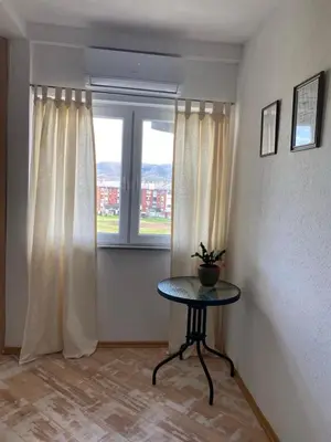 a room with a table in front of a window at Apartman Fad in Bihać