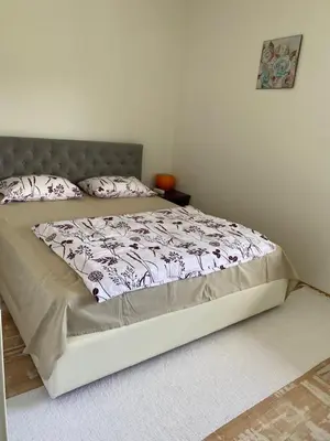 a large bed in a bedroom with a bed frame at Apartman Fad in Bihać