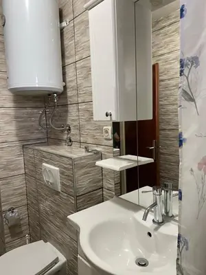 a bathroom with a white sink and a mirror at Apartman Fad in Bihać