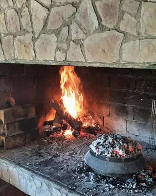 a brick fireplace with a cake in front of it at Kuća za odmor Noah in Bihać