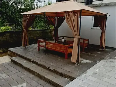 a large tent with a bed under it on a patio at Kuća za odmor Noah in Bihać
