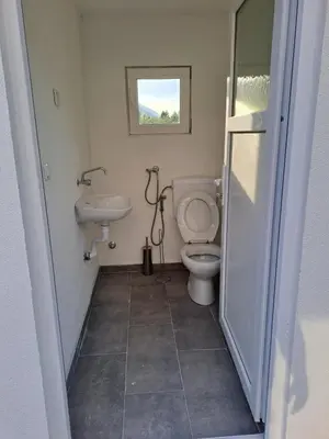 a bathroom with a toilet and a sink at Kuća za odmor Noah in Bihać