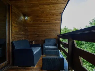 two chairs sitting on a deck with a balcony at Home of Peace at the top of the Pyramid Sun and Love in Visoko
