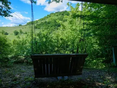 a swing in a yard with a tree at Home of Peace at the top of the Pyramid Sun and Love in Visoko