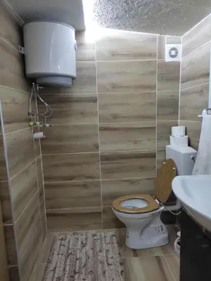 a bathroom with a toilet and a sink at Home of Peace at the top of the Pyramid Sun and Love in Visoko